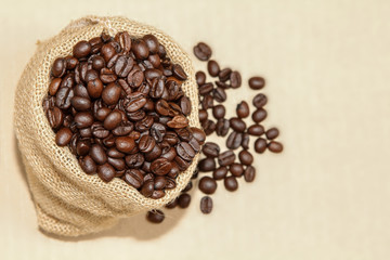 Coffee beans in burlap sack, top view.