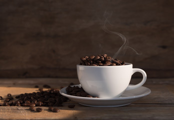 Still life coffee cup and roasted beans on old wood background