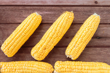 Fresh sweet corn on wooden table