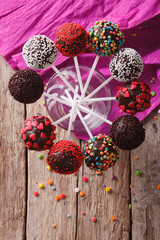 Delicious colorful cake pops in a glass. vertical top view
