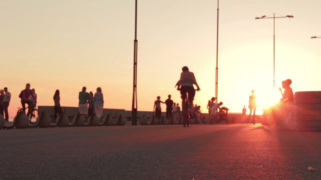 Promenade in big city at sunset