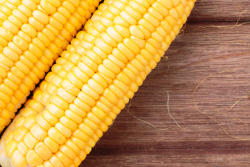 Fresh sweet corn on wooden table