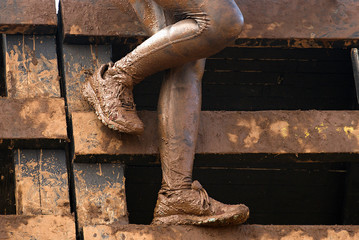 Mud race runners muddy feet