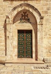 Fototapeta na wymiar Green door in the Church of the Holy Sepulchre in Jerusalem, Israel
