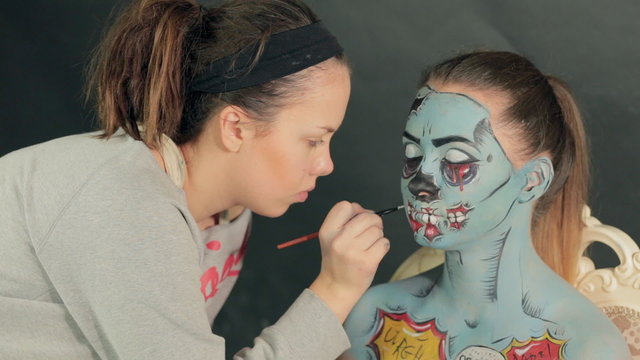 Halloween face art, application of make-up by makeup artist