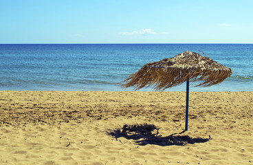 an umbrella on a windy beach