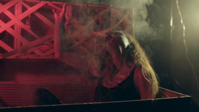 Creepy zombie in a coffin in the smoke