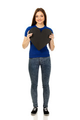 Happy teenager holding paper heart.