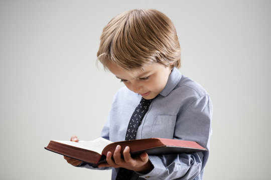 Child reading a book or bible
