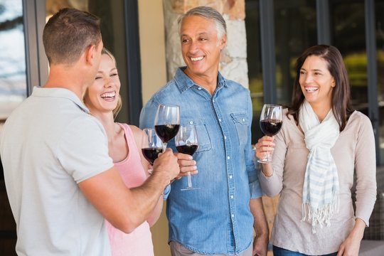 Happy friends in a wine tasting having wine