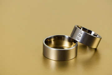 Wedding Rings on Golden Background