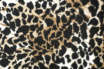 Brown and black leopard fur pattern. Spotted animal print as background.