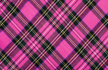 Scottish tartan pattern. Magenta pink and black plaid print as background. Symmetric rhombus pattern.