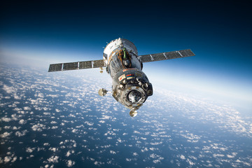 Spacecraft Soyuz over the planet earth