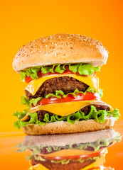 Tasty and appetizing hamburger on a yellow