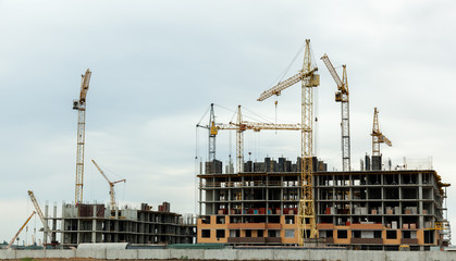 Fototapeta na wymiar construction of houses, construction cranes, construction materi