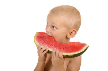 Cute little boy eating watermelon