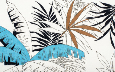 Tropical leaves pattern on white fabric. Black with blue and brown palm leaves print as background.