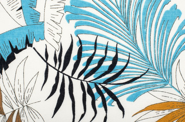 Tropical leaves pattern on white fabric. Black with blue and brown palm leaves print as background. - 90622227
