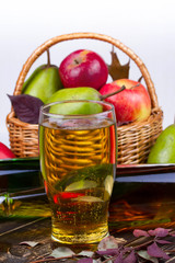Glass and bottles of cider. Apples and pears