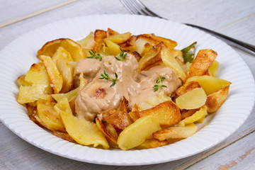 Chicken breasts in mushroom creamy sauce and home fried potatoes