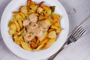 Chicken breasts in mushroom creamy sauce and home fried potatoes
