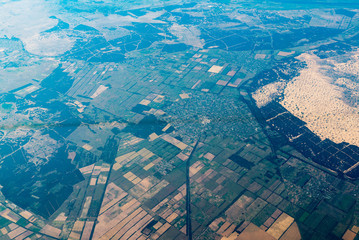 air view on landscape with geometric shaped vegetable gardens 