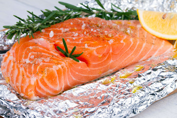 Fresh salmon ready for cooking on the foil paper