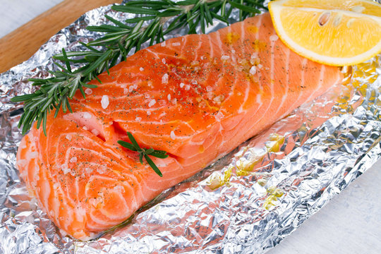 Fresh salmon ready for cooking on the foil paper