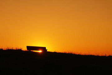 Fototapeta premium stone bench at sunset