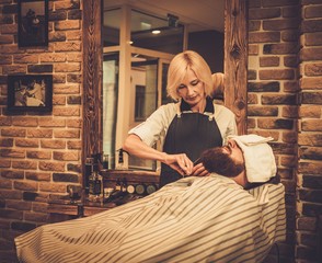 Client during beard and moustache grooming in barber shop