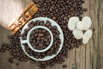 Coffee cup and coffee bean on a wooden table