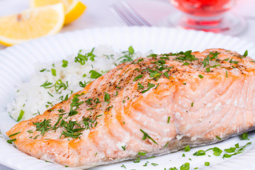 Steamed salmon with fresh herbs and lemon. Rice as a garnish