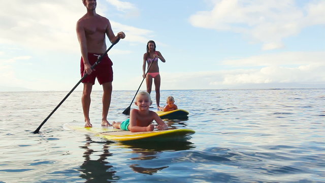 Family Stand Up Paddling on Sunny Blue Sky Morning. Summer Fun Family Vacation Healthy Lifestyle. Learning to Surf. SUP.