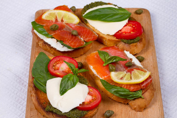 Salmon, Mozzarella, Tomatoes, Lemon, Capers and Pesto Sauce Bruschetta