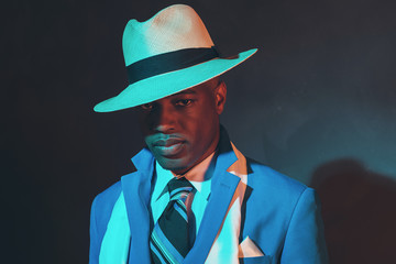 African american dandy man in blue suit and straw hat.