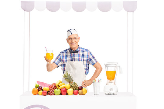 Mature soda jerk holding a glass of orange juice