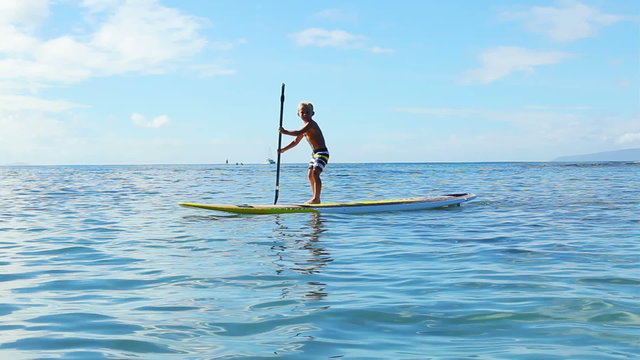Stand Up Paddling in Hawaii. Cute Young Blonde Boys Brothers Paddling Surfboard Together.