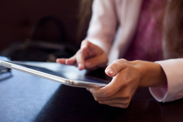 girl works on the digital tablet, a small depth of field, soft