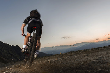 mountainbiker on the limit to keep his mountain trail