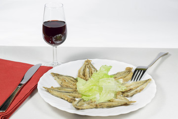 Dish of Mediterranean anchovies with salad and Rioja wineglass