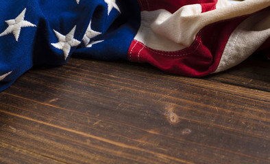 Old American Flag on wooden plank background