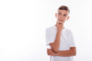 Cute male teenager is thinking about something