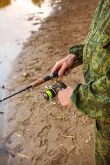 spool of fishing line on a spinning in the hands of a fisherman,