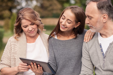 Cute mature family are watching a laptop