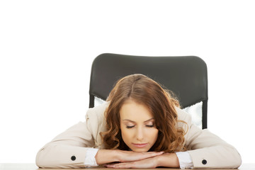 Businesswoman having a nap at her desk.