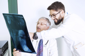 doctors examining an X-ray of a woman's body