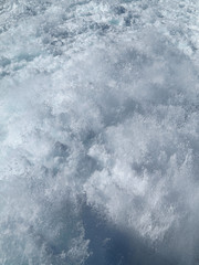 Trail on water surface behind of fast moving ferryboat