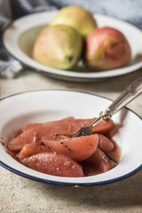 Poached pears with brandy sauce in autumn