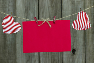 Holiday card and hearts hanging on clothesline
